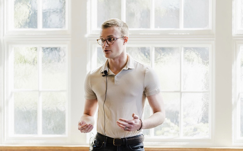Jackson presenting to an audience in a well-lit room.